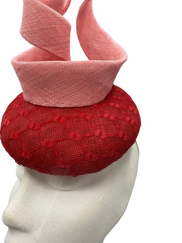 Red pillbox with baby pink structured swirl detail.